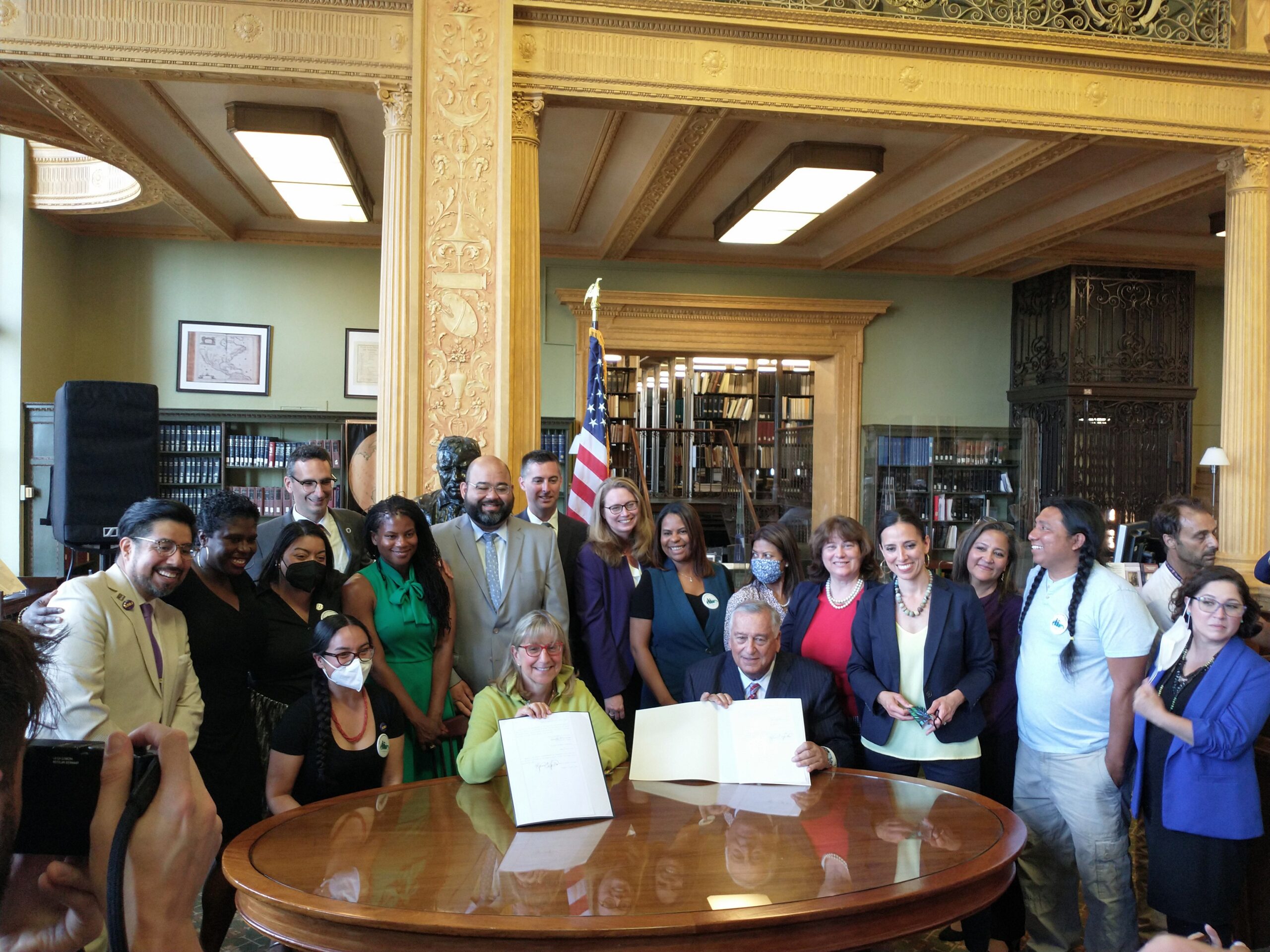 Driving Families Forward Coalition leaders with legislative champions at historic signing ceremony for the Work and Family Mobility Act on June 13, 2022.